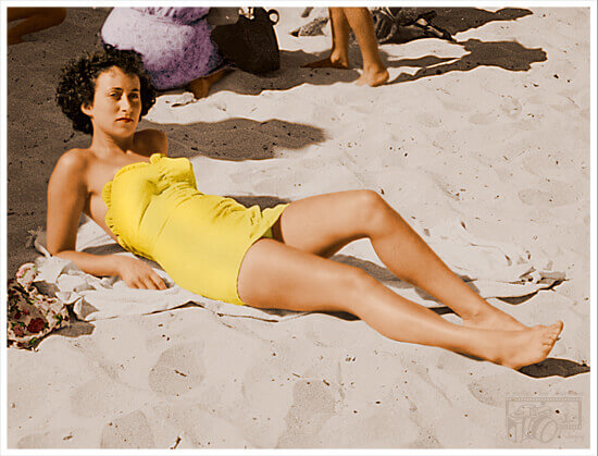 Photo of lady sunbathing on beach now colorized.