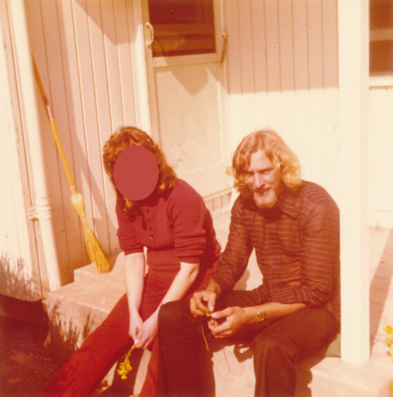 Original, photo of two people sitting on a porch / verandah.