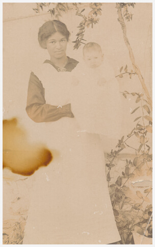 Original, B&W damaged photo of a Nanny holding a child.