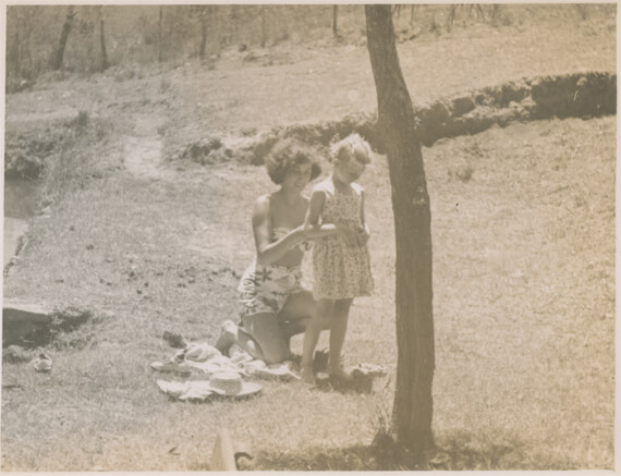 Original, photo of mother and child with a tree in the foreground obstructing the overall composition.