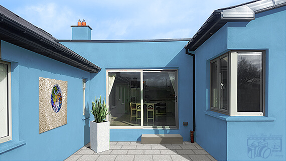 Image of the newly renovated house with gray walls and a neglected looking courtyard resembling a building site - now transformed with the walls freshly painted; courtyard paved; steps renovated; an outdoor mural and plants in a decorative pot added.